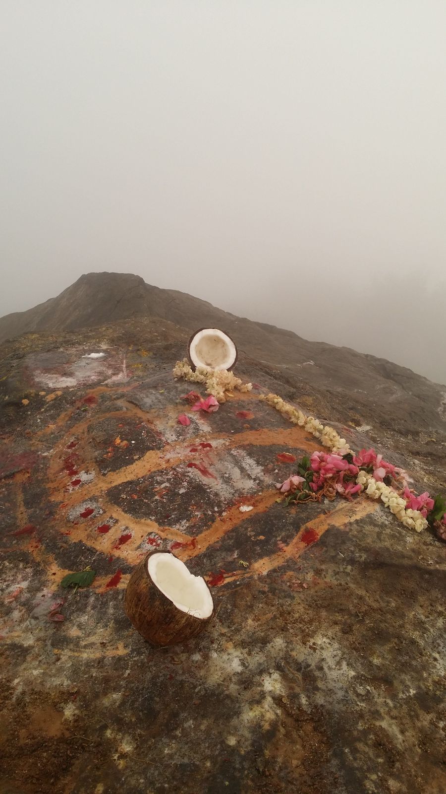 The consecrated lingam on the summit rock, the peak of Arunachala behind in mist